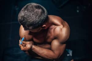 How to self-inject testosterone — man administering intramuscular TRT injection at home